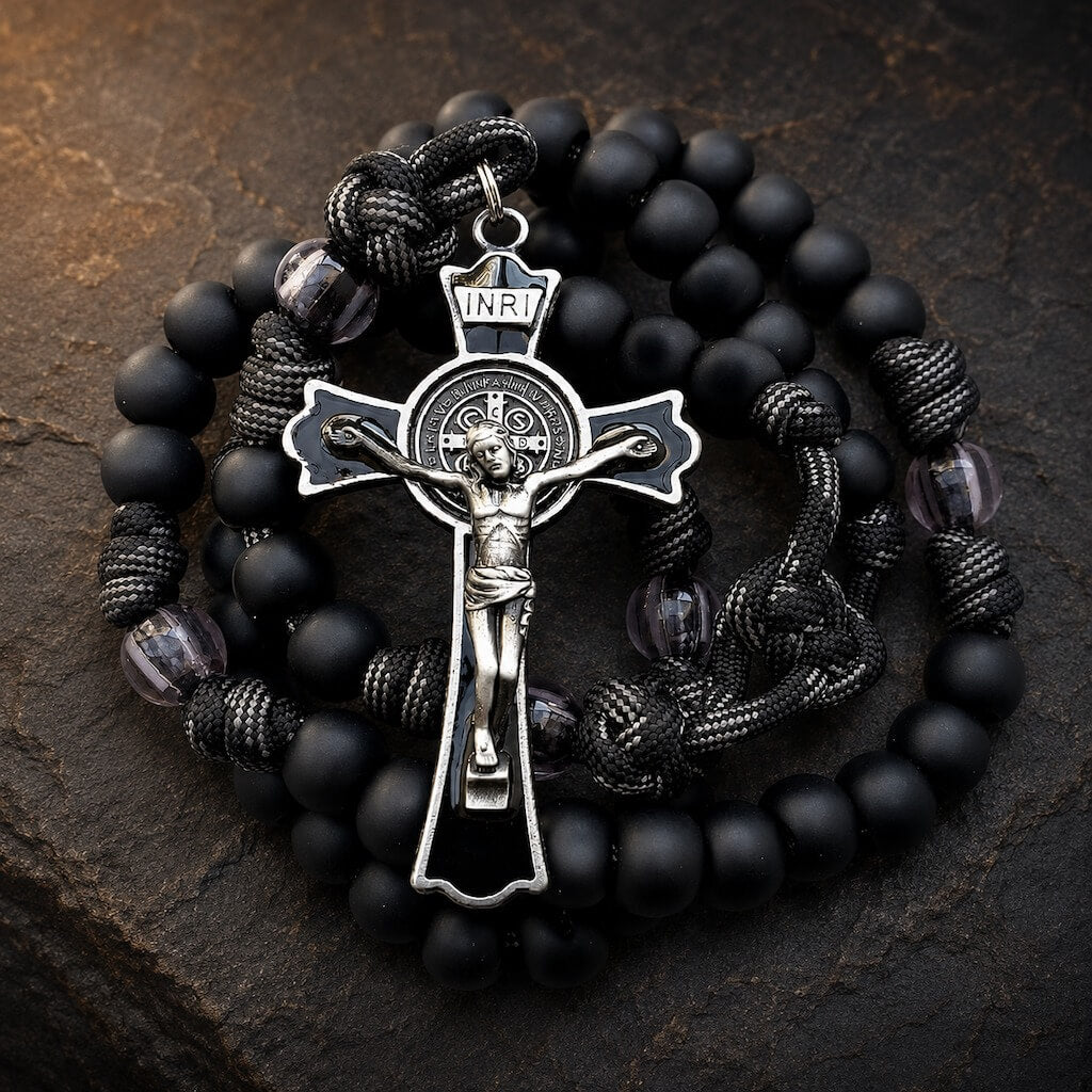 Black Monk five-decade rosary with matte black beads, knotted cord, clear accents, and a black enamel St. Benedict crucifix.
