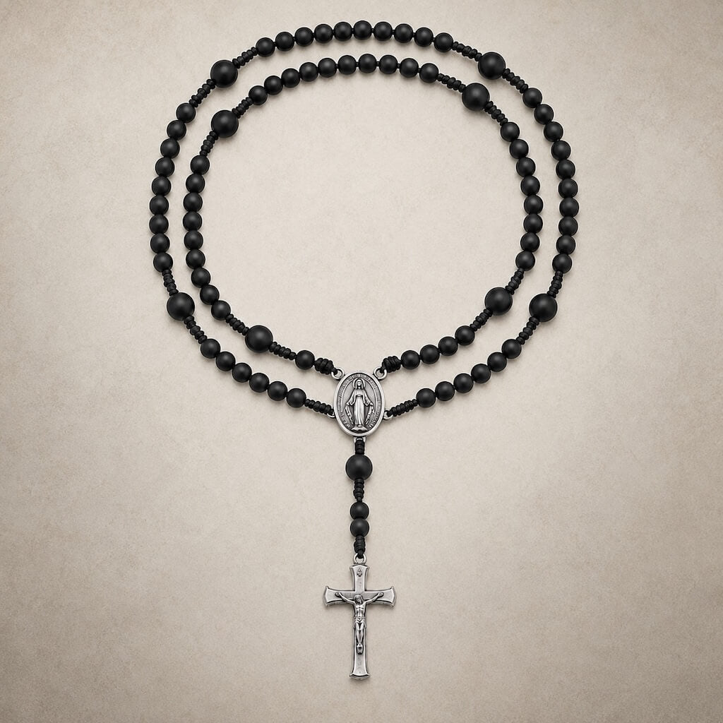 Black Compact Everyday Rosary with matte beads, a Miraculous Medal centerpiece, and a silver-tone crucifix.