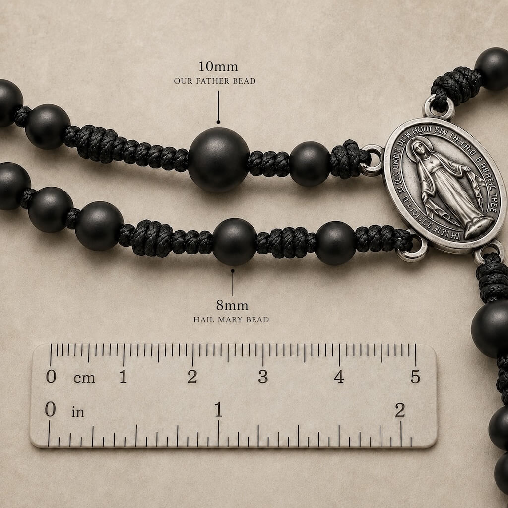Close-up comparing the 8 mm Hail Mary beads and 10 mm Our Father beads on the Compact Everyday Rosary.