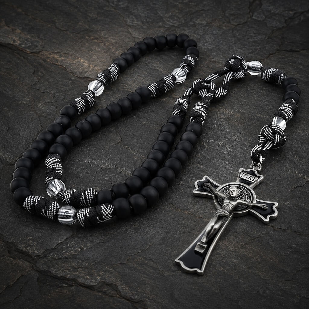 Heavy-duty black St. Benedict rosary with matte beads, thick knotted cord, clear accent beads, and a large black crucifix.