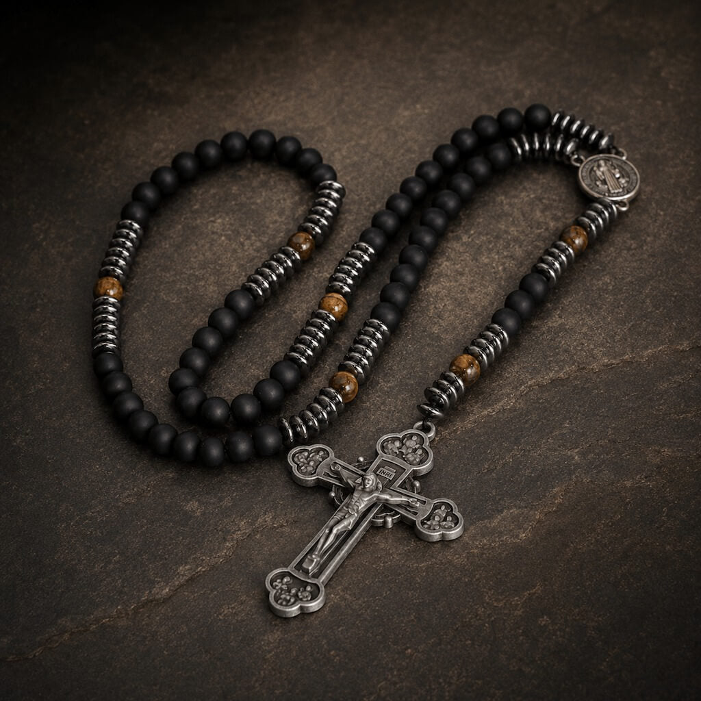 Heritage St. Benedict five-decade rosary with matte black beads, tiger eye accents, and an antiqued silver-tone crucifix on dark stone.