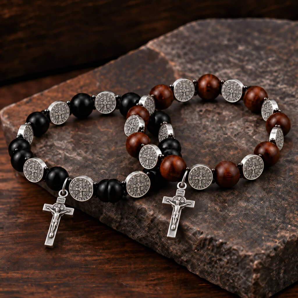 Black and dark brown St. Benedict wood bracelets with silver-tone medals and crucifixes displayed together