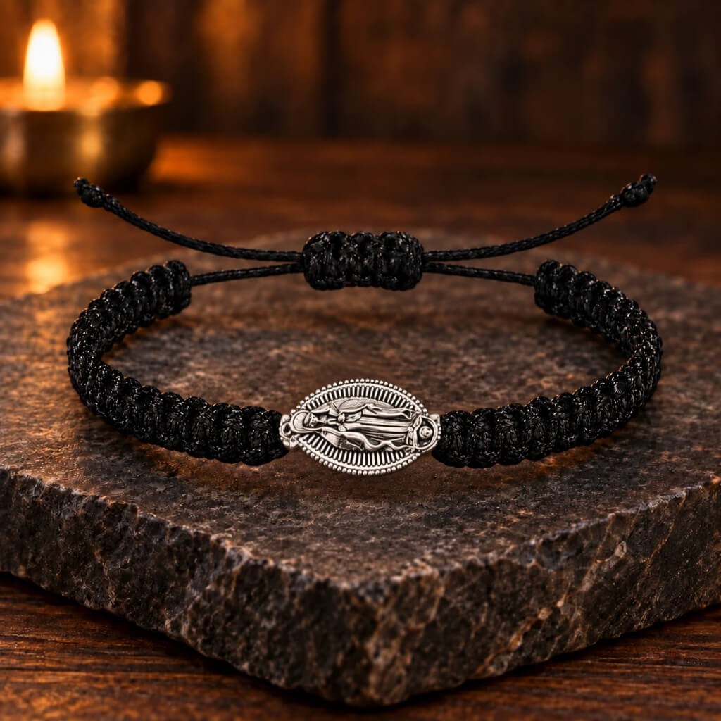 Black adjustable cord bracelet with silver-tone Virgin Mary medal on dark stone