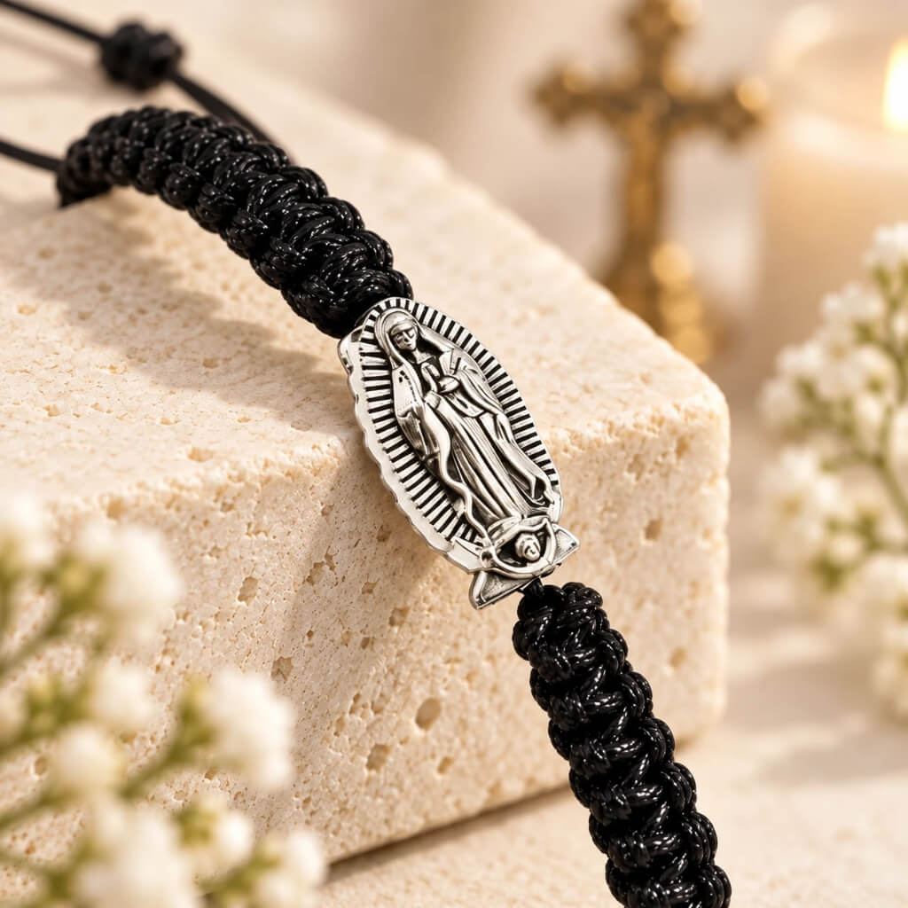 Close-up of Virgin Mary medal and black braided cord on adjustable Catholic bracelet